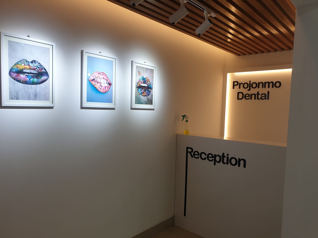 Projonmo Dental reception side view with artwork gallery wall