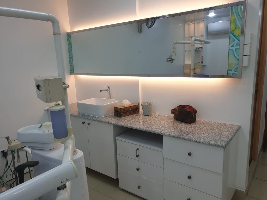 Projonmo Dental treatment room with granite counter and backlit mirror